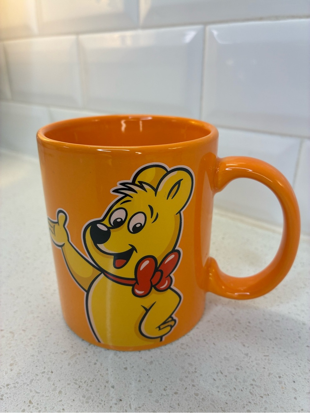 HARIBO Orange Ceramic Mug featuring the Yellow HARIBO Bear